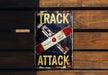 a sign on a wooden wall that says track attack