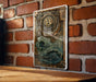 a bitcoin sign mounted to a brick wall