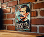 a picture of a man with a mustache hanging on a brick wall