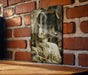 a brick wall with a picture hanging on it