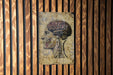 a painting of a human head on a wooden wall