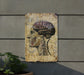 a painting of a human head on a wall