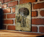 a picture of a human head on a brick wall