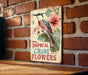 a sign on a brick wall that says tropical cranee's flowers