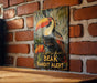 a picture of a toucan on a brick wall