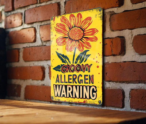 a yellow sign on a brick wall that says grooy allergen warning
