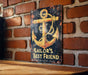 a sign on a brick wall that says sailor's best friend