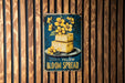 a sign on a wooden wall that says yellow bloom spread