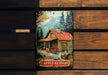 a painting of a cabin on a wooden wall