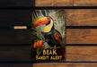 a picture of a toucan bird on a bench