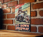 a sign on a brick wall that says sit down speedway