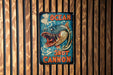 a sign on a wooden wall that says ocean shot cannon
