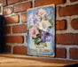 a picture of a bouquet of flowers on a brick wall