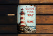 a sign on a wooden bench that says guide your way home