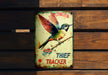 a tin sign with a hummingbird on it