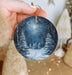 a person holding a christmas ornament in their hand