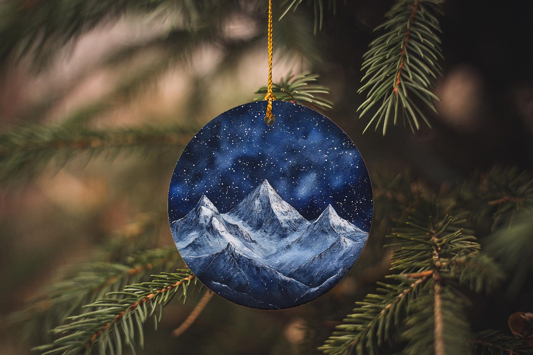 a blue ornament hanging from a christmas tree