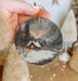 a person holding a christmas ornament in their hand