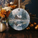 a christmas ornament with a picture of a cabin in the snow