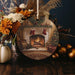 a christmas ornament with a fireplace in the background