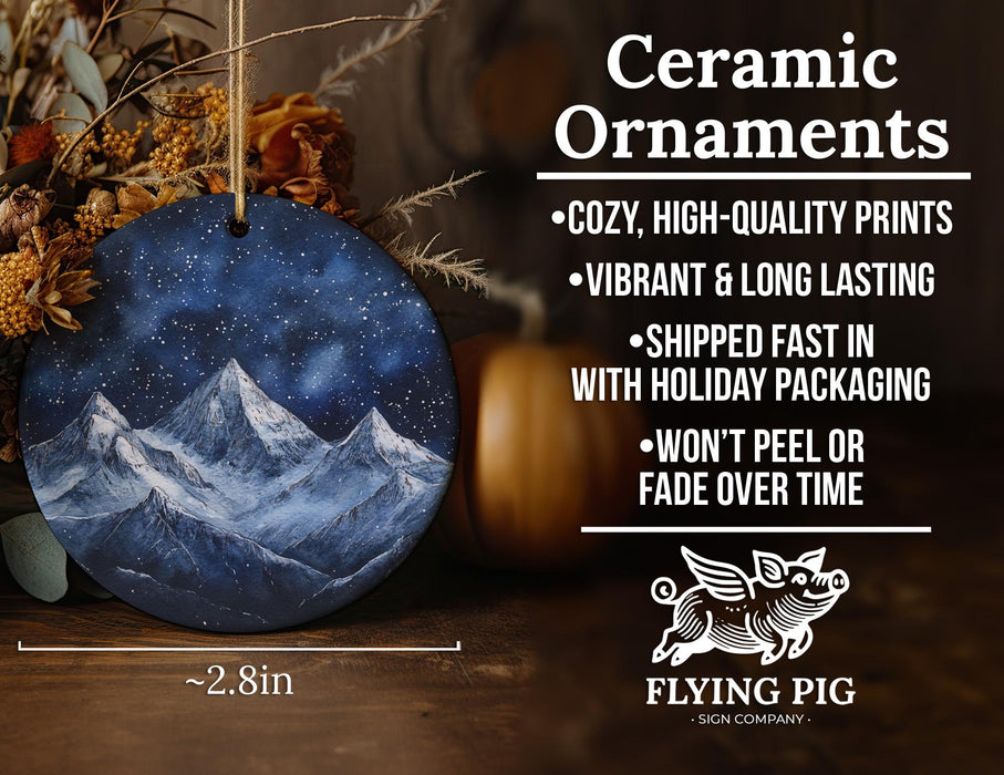 a ceramic ornament with a mountain scene on it