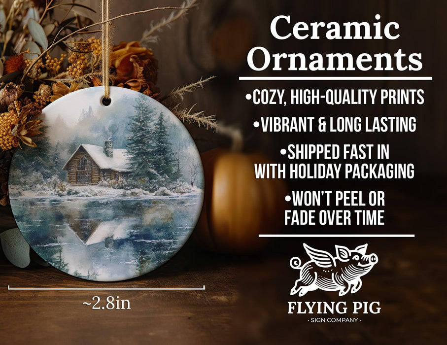 a ceramic ornament with a picture of a cabin in the woods