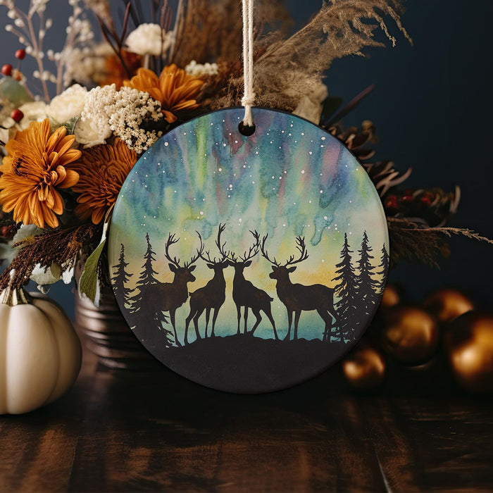 a christmas ornament with two deer in the woods
