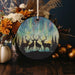 a christmas ornament with two deer in the woods