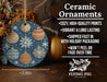 a ceramic ornament with a blue background and white snowflakes