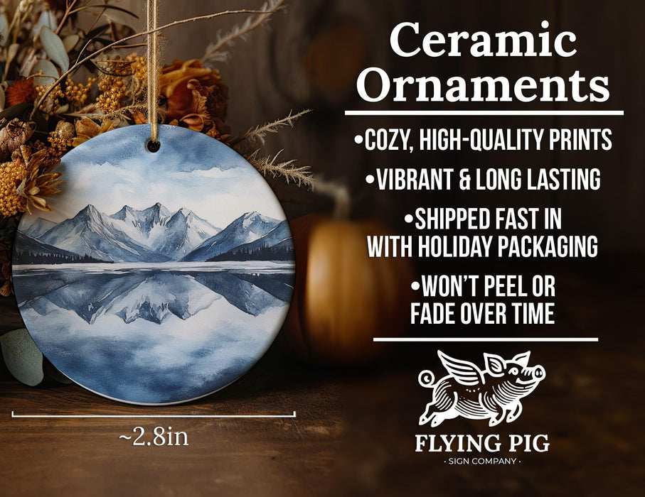 a ceramic ornament with a mountain scene on it