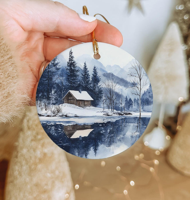 a person holding a christmas ornament in their hand