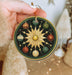 a person holding a christmas ornament in their hand
