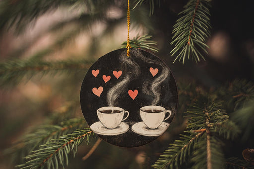 a couple of cups of coffee hanging from a christmas tree