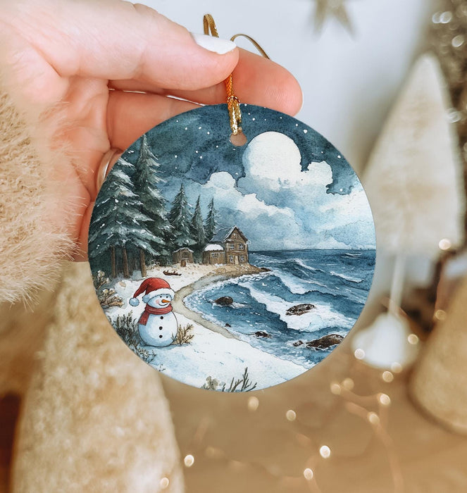 a person holding a christmas ornament in their hand