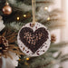 a heart shaped ornament hanging from a christmas tree