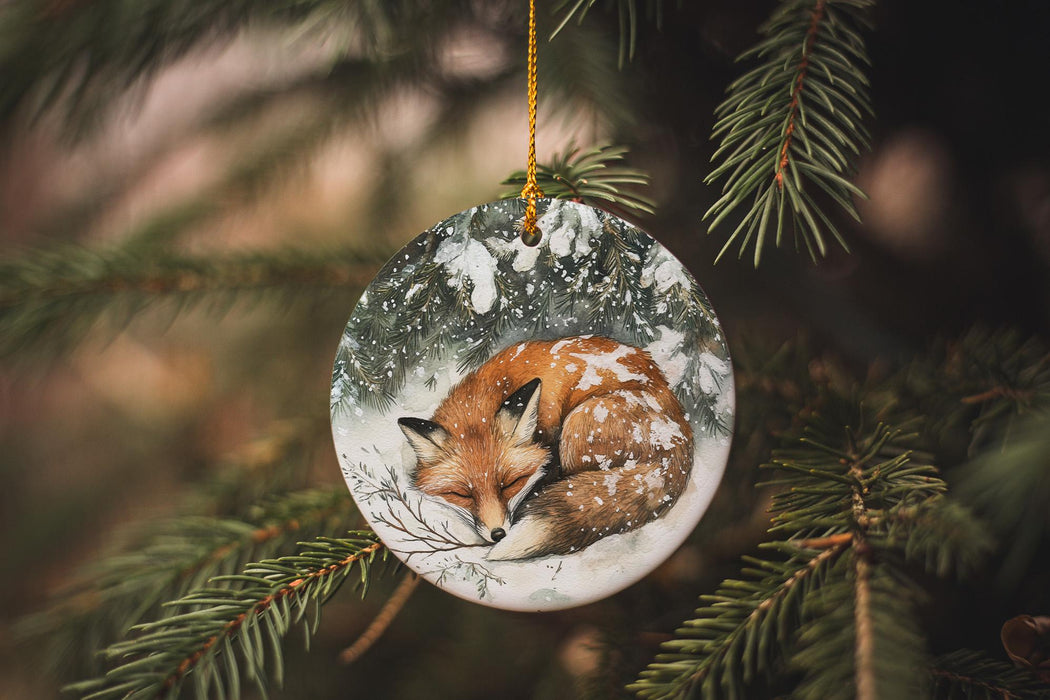 a glass ornament with a sleeping fox on it