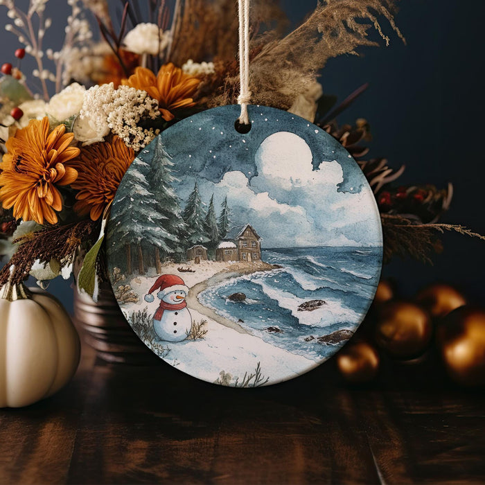 a christmas ornament with a painting of a snowman