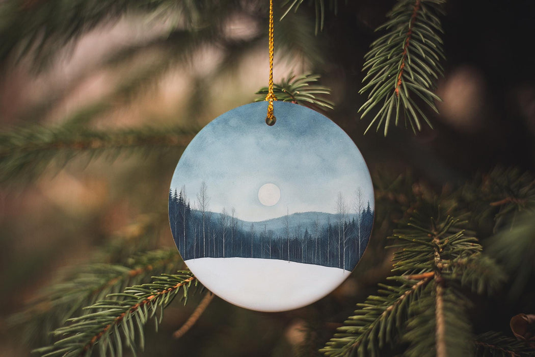 a ceramic ornament hanging from a christmas tree