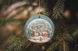 a glass ornament hanging from a christmas tree