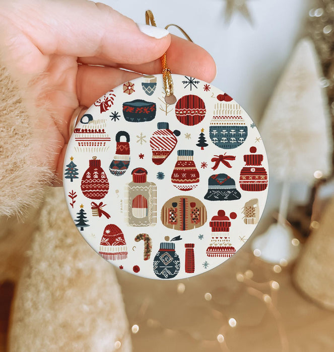 a person holding a christmas ornament in their hand