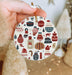 a person holding a christmas ornament in their hand