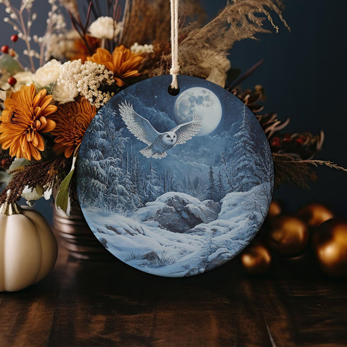 an ornament with a picture of an eagle flying over a snowy mountain
