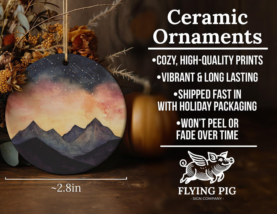 a ceramic ornament with a mountain scene on it