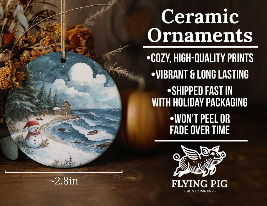 a ceramic ornament with a painting of a snowy scene