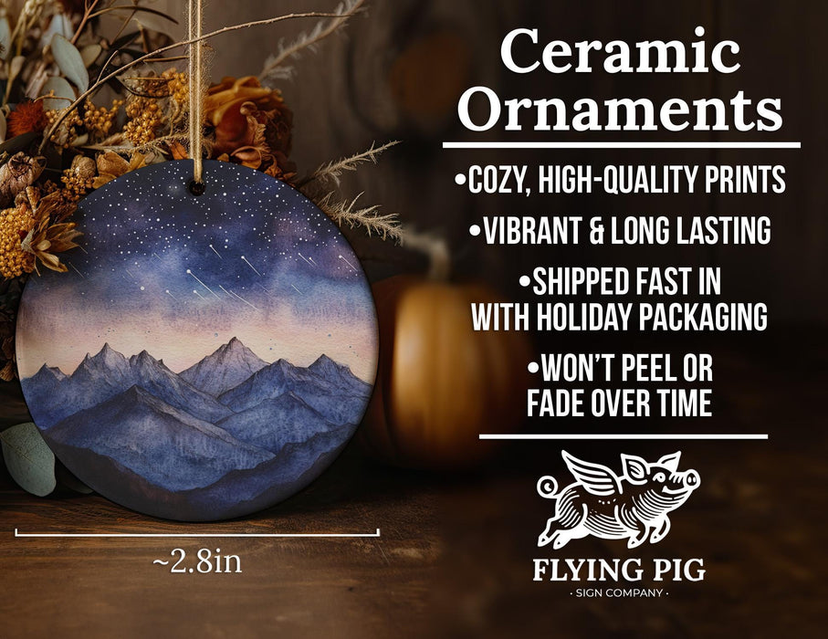 a ceramic ornament with a mountain scene on it