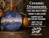 a ceramic ornament with a mountain scene on it