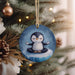 a penguin ornament hanging from a christmas tree