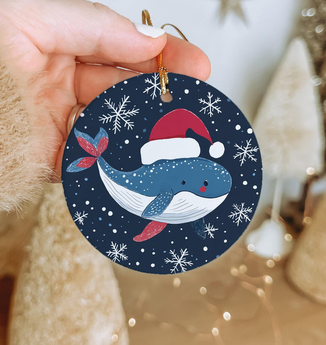 a person holding a christmas ornament in their hand