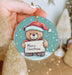 a person holding a christmas ornament in their hand