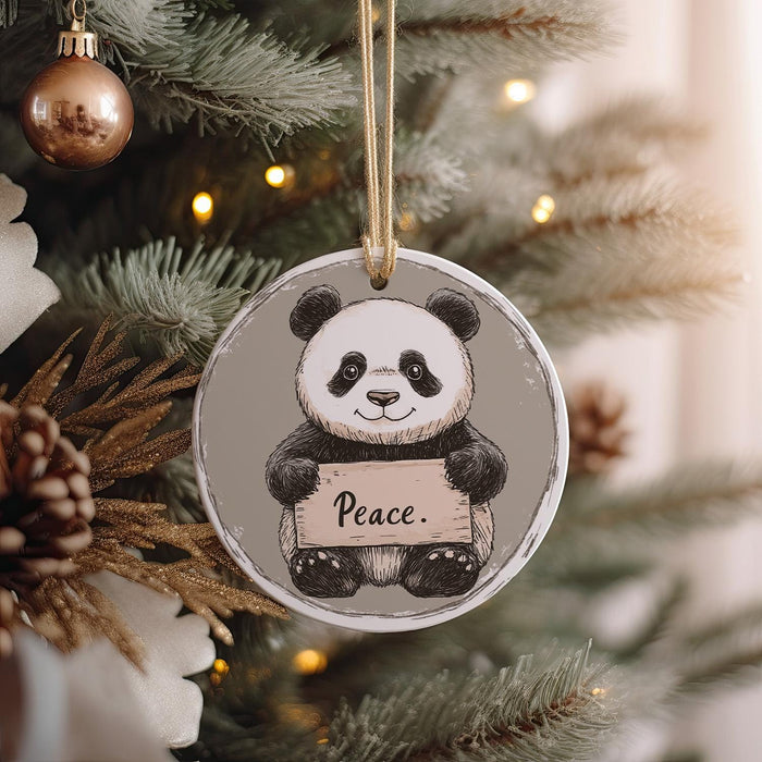 a panda bear ornament hanging from a christmas tree